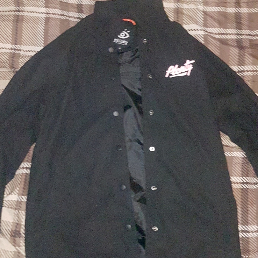 Small black plenty human wears coach jacket
